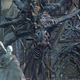 The Lesser Amygdala, hanging on a church wall, stares at a Bloodborne Hunter, watching as Yharnam's denizen succumb to madness.